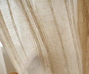 Close-up of beige linen fabric texture with vertical stripes and natural soft drapery