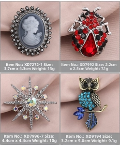 Close-up of four vintage alloy brooches featuring pearls, ladybugs, and colorful rhinestones