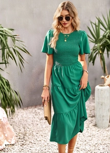 Detail view of the green tiered vacation dress with smocked bodice and ruffle sleeves