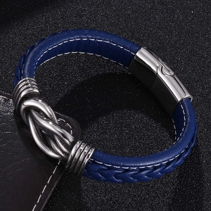 Detailed macro view of blue braided leather bracelet with silver infinity metal clasp