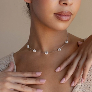 Silver pearl flower necklace in titanium steel, fashion jewelry set for women worn by model
