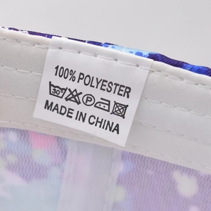 Macro detail of the 100% polyester fabric label and care icons on graffiti baseball cap
