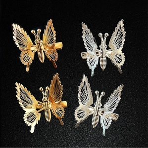 Set of four hollow metal butterfly hair clips in gold and silver with duckbill grips