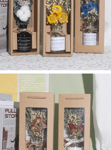 Close-up of dried flower bouquet in glass bottle within a kraft window gift box