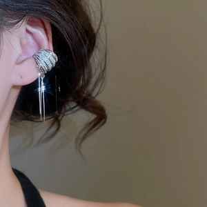 Close-up of a silver zircon flower ear cuff with sparkling long tassel chains