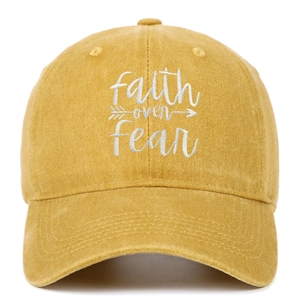 Detail view of Faith Over Fear embroidery on ginger yellow washed cotton baseball cap