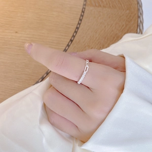 Close-up of S925 sterling silver chain link ring with zircon stones on silk fabric