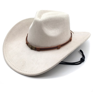 Detail of off-white cowboy hat with brown leather band and bronze skull ornament