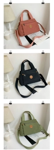 Detailed view of canvas tote bags in pink, black and green with adjustable straps