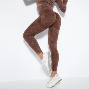 Detail of high-waist seamless yoga leggings with acid wash texture and peach lift design