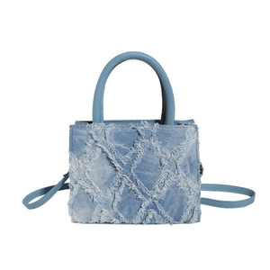 Blue denim tote bag with frayed diamond quilted texture and top handles for women