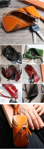 Detailed view of genuine leather zipper key cases in multiple vintage colors on wooden desk