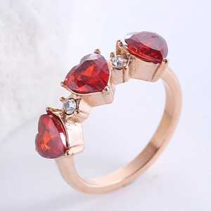 Rose gold hip hop ring with three red heart-shaped zircon stones and pavé set crystals