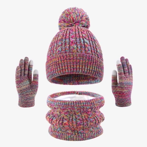 Detail of colorful knitted hat, neck warmer and touchscreen gloves with soft pompom