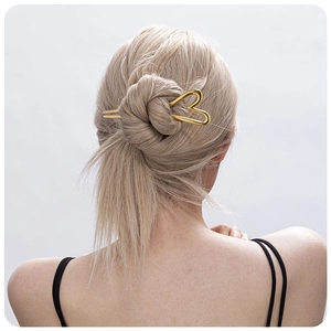 Minimalist 18K gold-plated stainless steel heart hair pin worn on a bun hairstyle