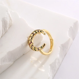 Detail of gold open ring with twisted band and colorful zircon star settings
