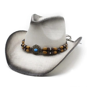 White woven straw Western cowboy hat with turquoise bead band on plain background