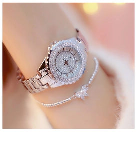 Luxurious silver women watch with full diamond bezel and matching chain on wrist