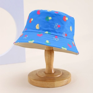 Close-up of blue cotton bucket hat with colorful mushroom prints and beige lining