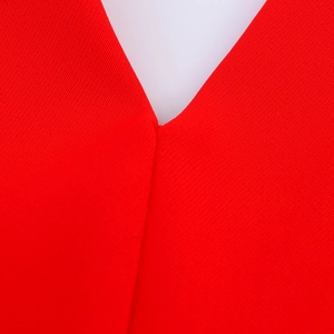 Dettaglio dello scollo a V rosso con trama in tessuto a maglia fine e finitura elegante