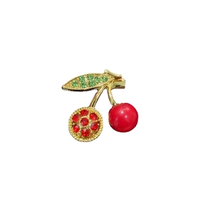 Cute cherry brooch with red rhinestones and green leaf in gold-plated alloy finish