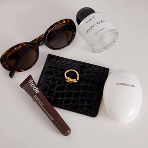 Luxury black crocodile pattern card holder with gold knot detail and chic accessories