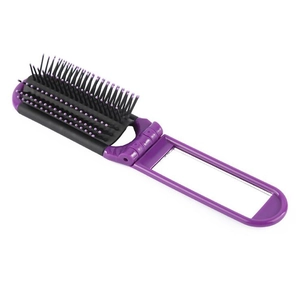 Detail showing the portable purple folding hairbrush with integrated compact makeup mirror