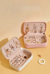 Close-up of portable jewelry organizer showing interior compartments for rings and necklaces