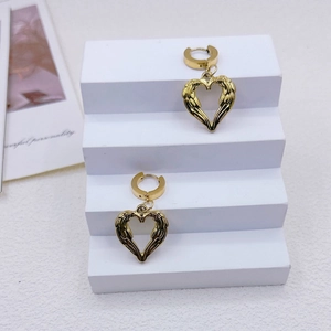 Three-piece stainless steel heart jewelry set with angel wings earrings on white stand