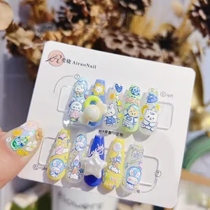 Detail view of 3D embossed press-on nails featuring cute bear, rabbit and candy motifs