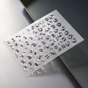 Macro detail of 3D resin eye stickers with glossy finish and diverse shapes
