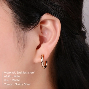 Detail view of 20mm C-shaped stainless steel earrings on ear with 4mm width