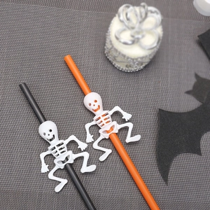 Detail of Halloween straws with 3D white skeletons climbing on orange and black plastic stems