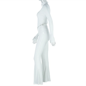 Detail of white ribbed knit fabric on long sleeve zip-up top and high waist pants