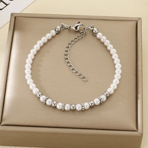 Close-up of elegant pearl and silver bead bracelet with adjustable chain on jewelry box