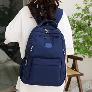 Stylish dark blue nylon backpack with multiple compartments for travel and daily use
