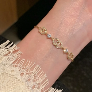 Detailed view of 18k gold plated bracelet featuring interlocking C design with sparkling zircons