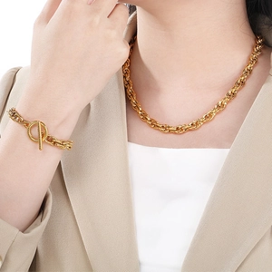 Gold tone twisted rope chain necklace and bracelet set with T-bar toggle clasp on model