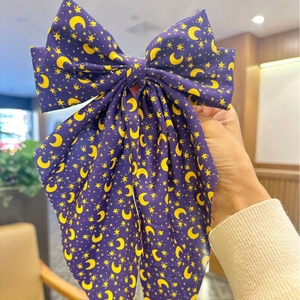 Purple bow hair clip with yellow crescent moon and star print for women's party hair