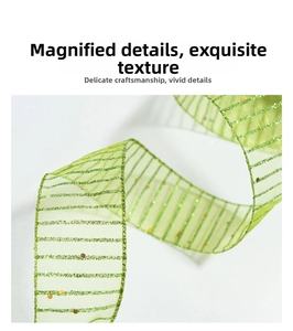 Close-up of light green sheer organza ribbon with green glitter stripes and gold sequins