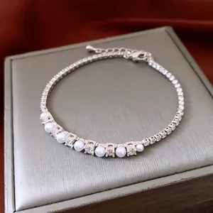 Adjustable French pearl and zircon chain bracelet in silver finish on a luxury jewelry box