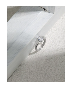 Detailed view of S925 silver ring featuring a square zircon stone on white textured wood