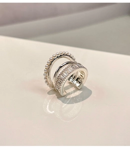 Detailed view of silver triple-layered ear cuff with pearls and zircon inlay for women