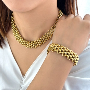 Chunky gold chain jewelry set featuring a heavy link necklace and matching bracelet
