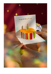 Detail of 3D pop-up birthday card with rainbow cake and Happy Birthday message