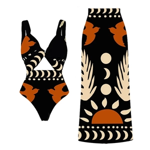 Detail of bohemian print bikini set with orange birds and moon patterns on a black base