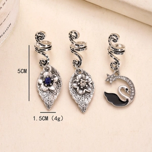 Three silver alloy dreadlock charms featuring flower leaves and swan with blue white gems