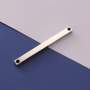 Close-up of polished stainless steel rectangular 3D bar pendant with dual hole design