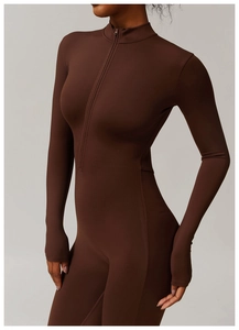 Close-up of the thumbhole cuffs and high-elastic matte fabric on the brown bodysuit