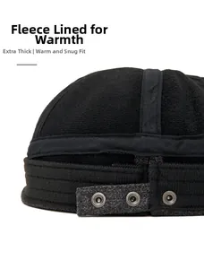 Detail of warm fleece lining and adjustable metal snap strap for a wool beret cap